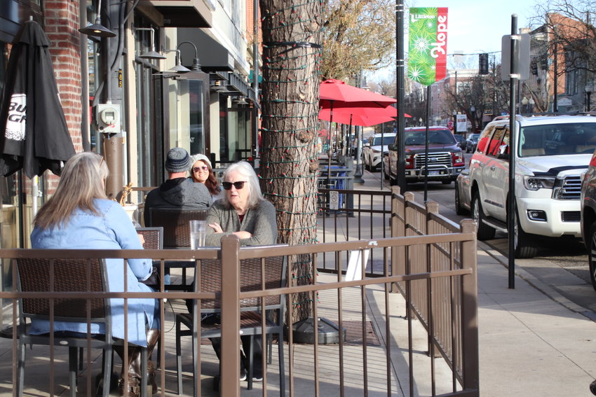 Diners sit outside Smokin Fins in downtown Littleton on Nov. 20, hours before new orders took effect ending indoor dining in the face of surging COVID-19 numbers.